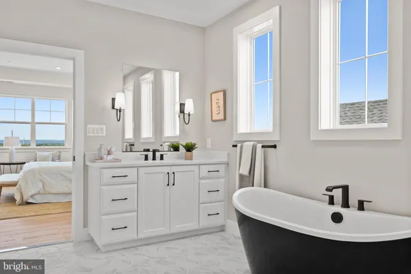 a living room with furniture and a dining table with kitchen view