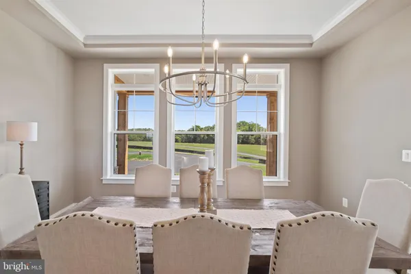 a dining room with furniture and wooden floor
