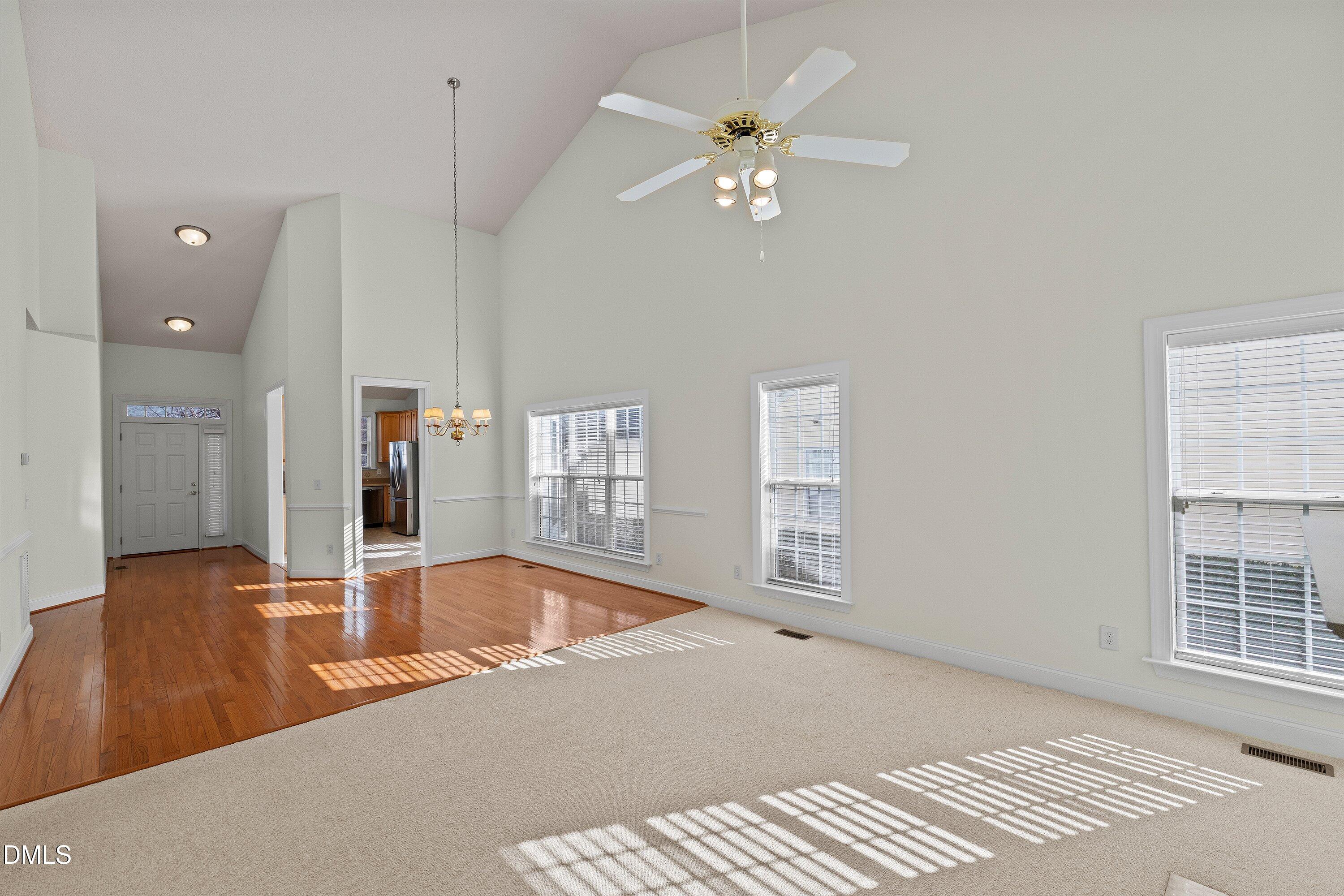 105 Rockport Ridge Way Cary, NC 27519 - Photo 18 of 43 a view of a livingroom with a dinning area hardwood floor and a ceiling fan