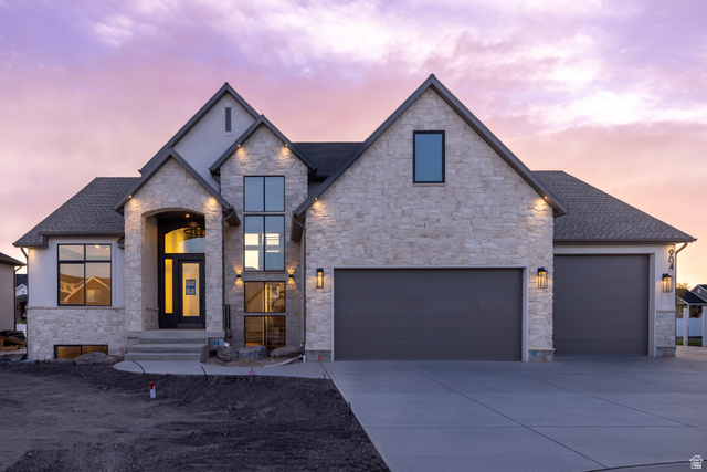 904 South 1900 West Layton, UT 84041 - Photo 1 of 19 View of front of house featuring stone and stucco, driveway, roof with asphalt shingles, and a garage