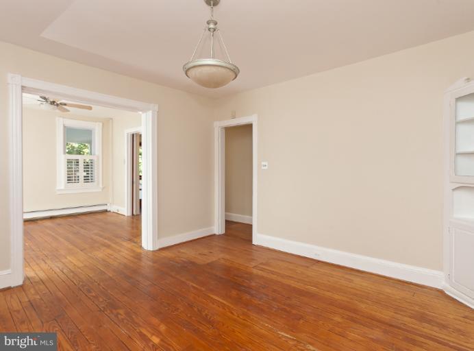 4612 Schenley Road Baltimore, MD 21210 - Photo 18 of 23 an empty room with wooden floor and windows