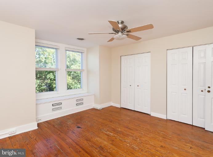 4612 Schenley Road Baltimore, MD 21210 - Photo 19 of 23 a view of empty room with wooden floor and fan