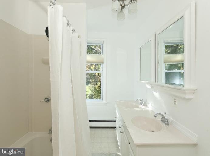 4612 Schenley Road Baltimore, MD 21210 - Photo 20 of 23 a bathroom with a sink a window and shower