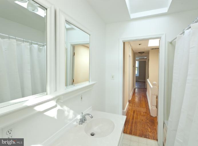 4612 Schenley Road Baltimore, MD 21210 - Photo 3 of 23 a bathroom with a sink and a mirror