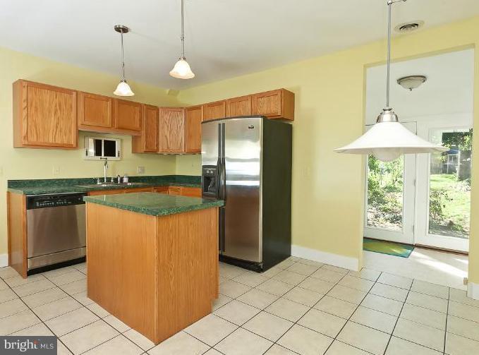 4612 Schenley Road Baltimore, MD 21210 - Photo 22 of 23 a kitchen with stainless steel appliances granite countertop a refrigerator a sink and a stove