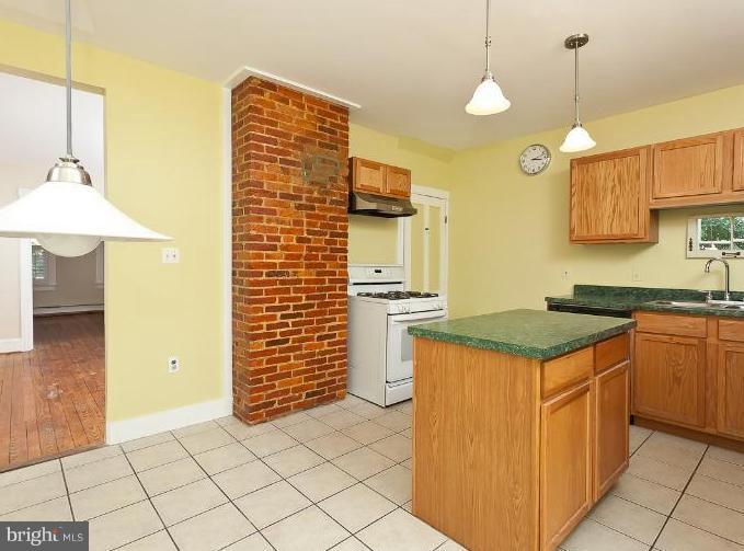 4612 Schenley Road Baltimore, MD 21210 - Photo 23 of 23 a kitchen with a stove and a kitchen island