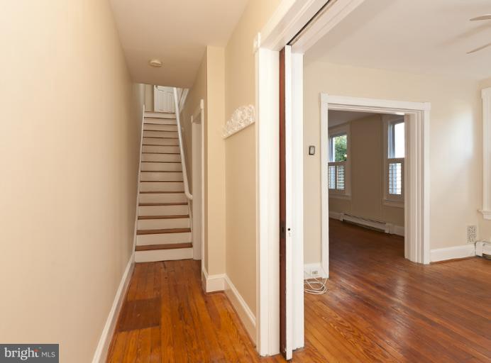 4612 Schenley Road Baltimore, MD 21210 - Photo 9 of 23 a view of a hallway with wooden floor and staircase