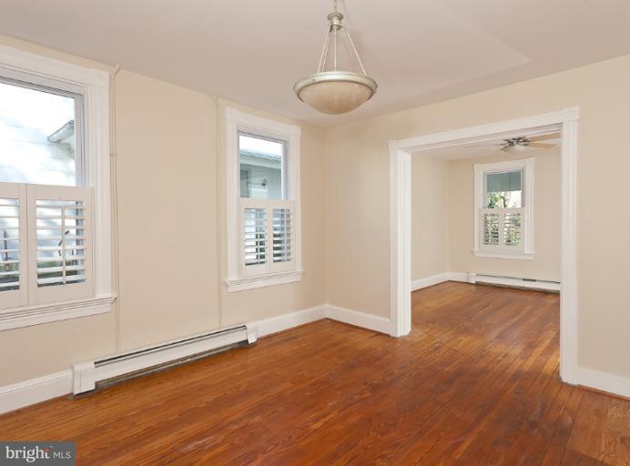 4612 Schenley Road Baltimore, MD 21210 - Photo 10 of 23 a view of an empty room with wooden floor and a window