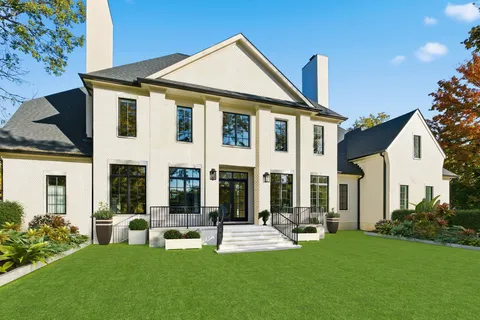 a front view of house with yard and outdoor seating