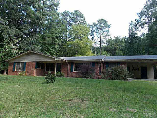 6220 Doyle Road Durham, NC 27712 - Photo 1 of 8 a front view of house with yard and green space