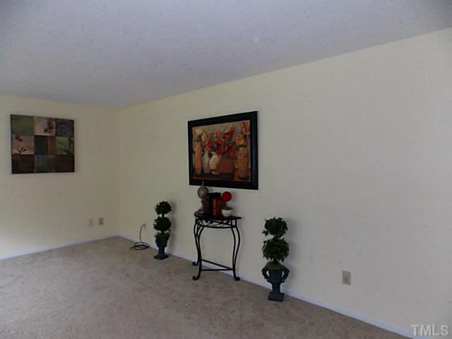 6220 Doyle Road Durham, NC 27712 - Photo 4 of 8 a room with painting on the wall and a window