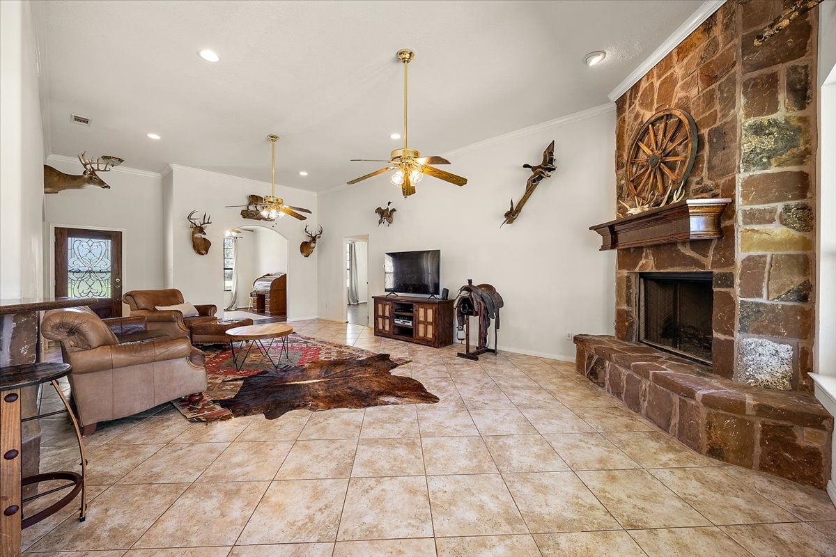 394 Farm To Market 230 Trinity, TX 75862 - Photo 11 of 50 a living room with furniture a fireplace and a flat screen tv