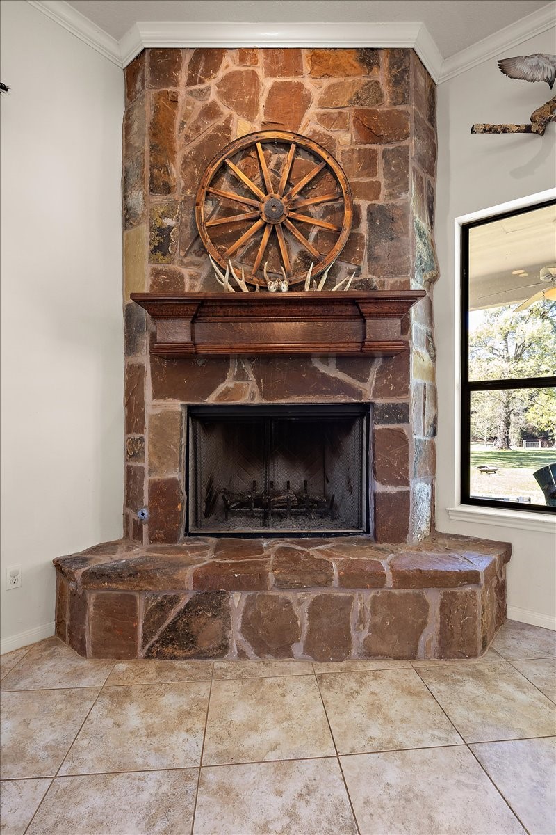 394 Farm To Market 230 Trinity, TX 75862 - Photo 14 of 50 a living room with a fireplace and a rug