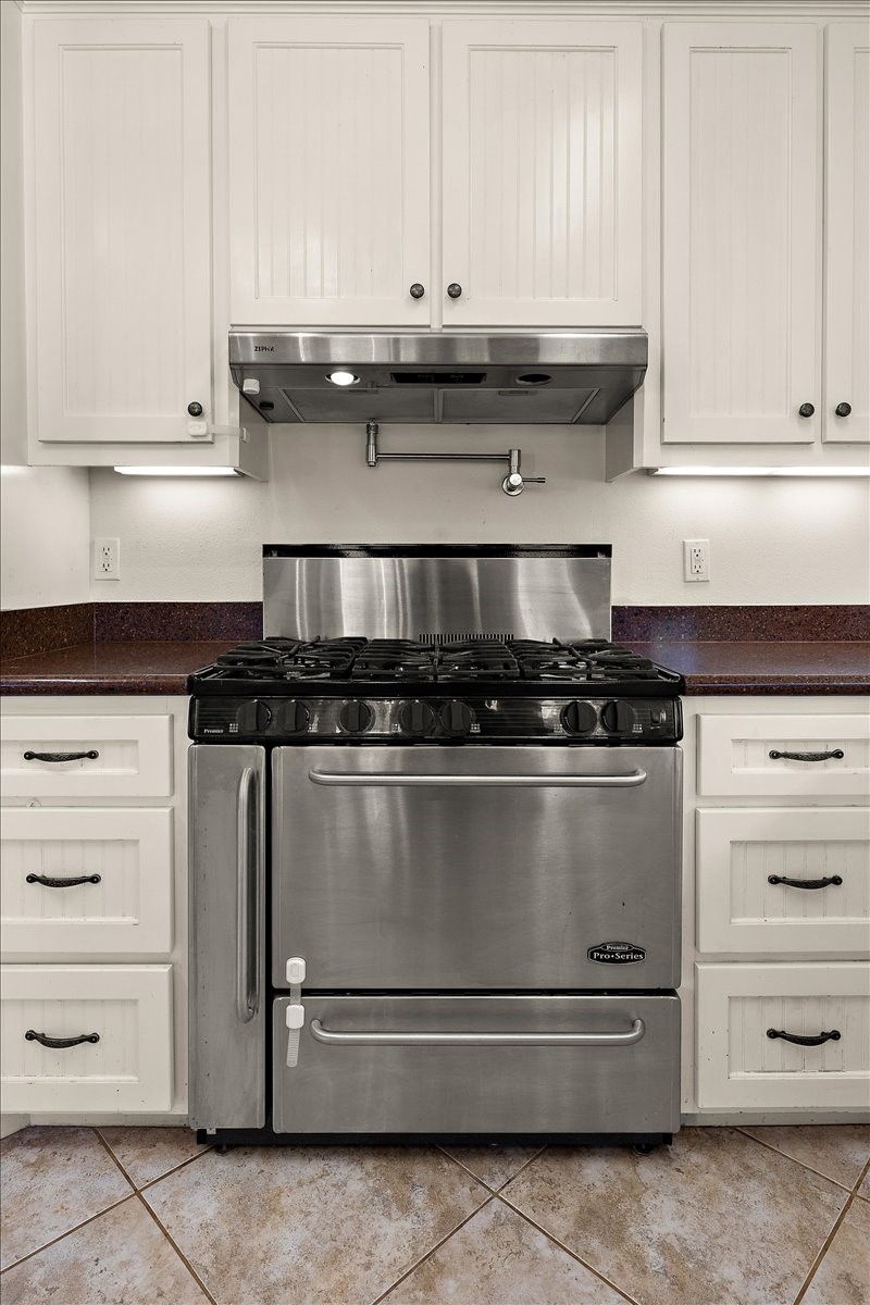 394 Farm To Market 230 Trinity, TX 75862 - Photo 19 of 50 a stove top oven sitting inside of a kitchen