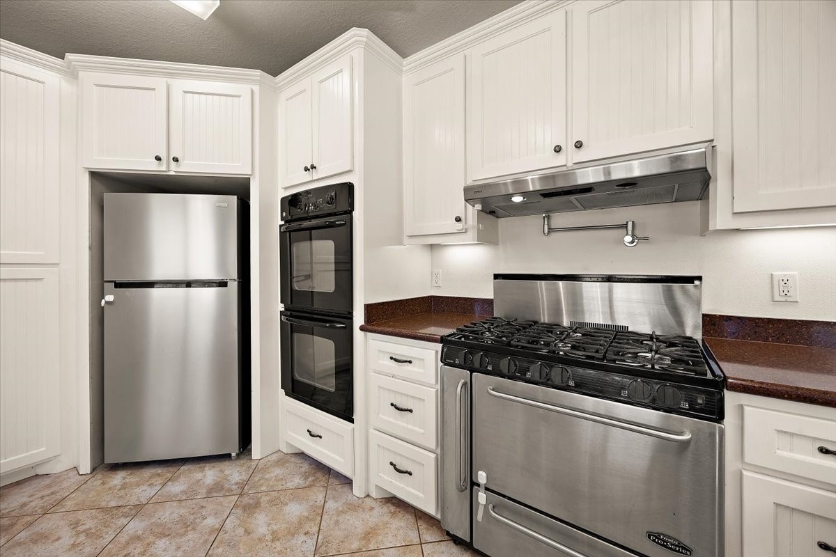 394 Farm To Market 230 Trinity, TX 75862 - Photo 20 of 50 a kitchen with white cabinets and refrigerator