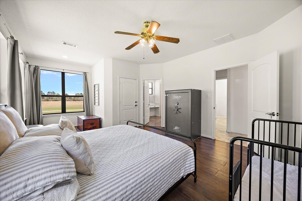 394 Farm To Market 230 Trinity, TX 75862 - Photo 25 of 50 a bedroom with a bed and a chandelier