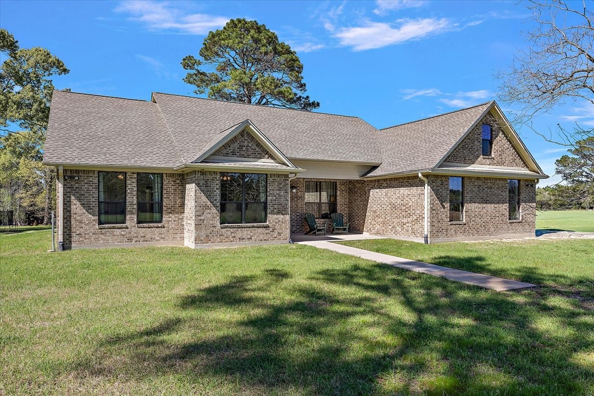 394 Farm To Market 230 Trinity, TX 75862 - Photo 3 of 50 a front view of a house with a garden and porch
