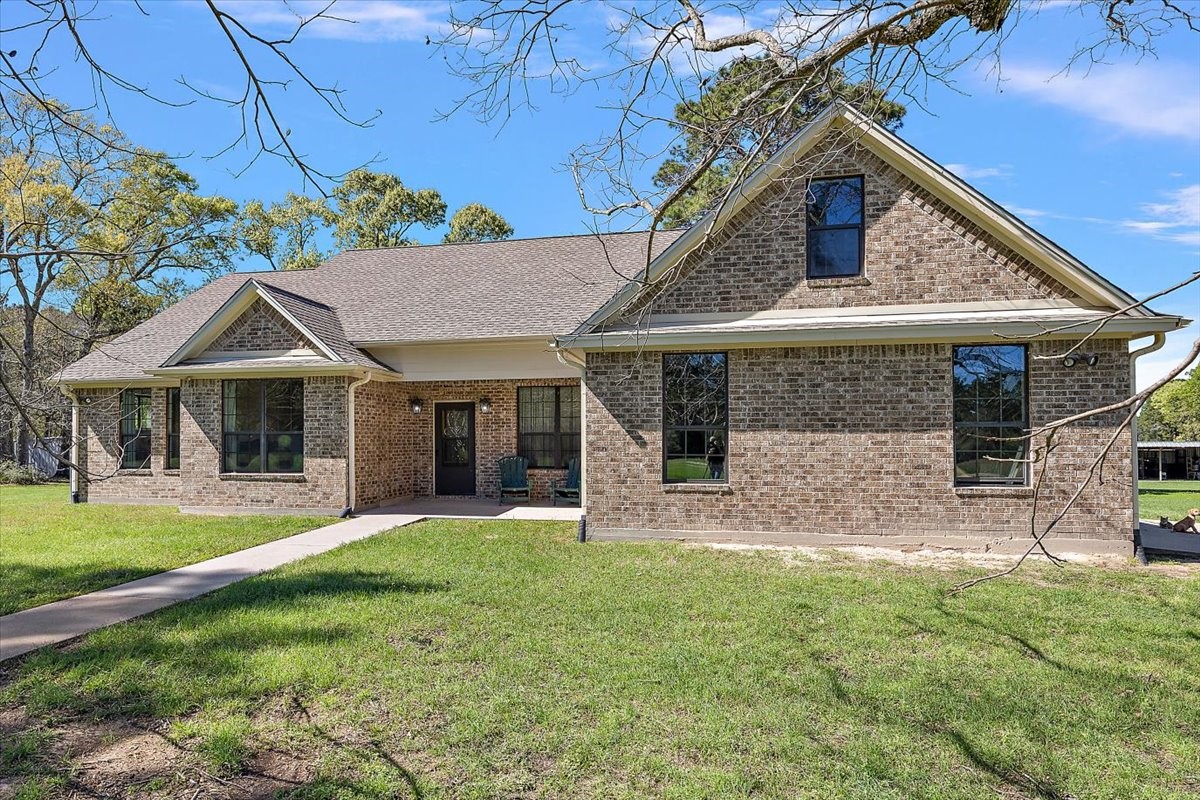 394 Farm To Market 230 Trinity, TX 75862 - Photo 5 of 50 a front view of a house with a yard