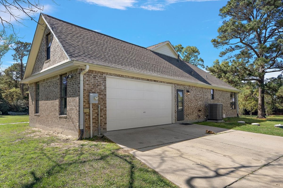 394 Farm To Market 230 Trinity, TX 75862 - Photo 6 of 50 a front view of a house with a yard and garage