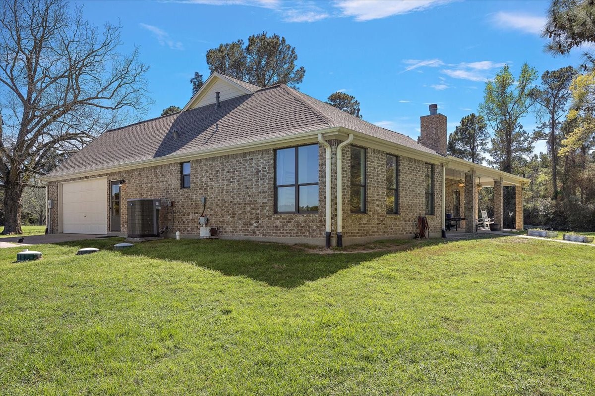 394 Farm To Market 230 Trinity, TX 75862 - Photo 7 of 50 a front view of a house with a yard