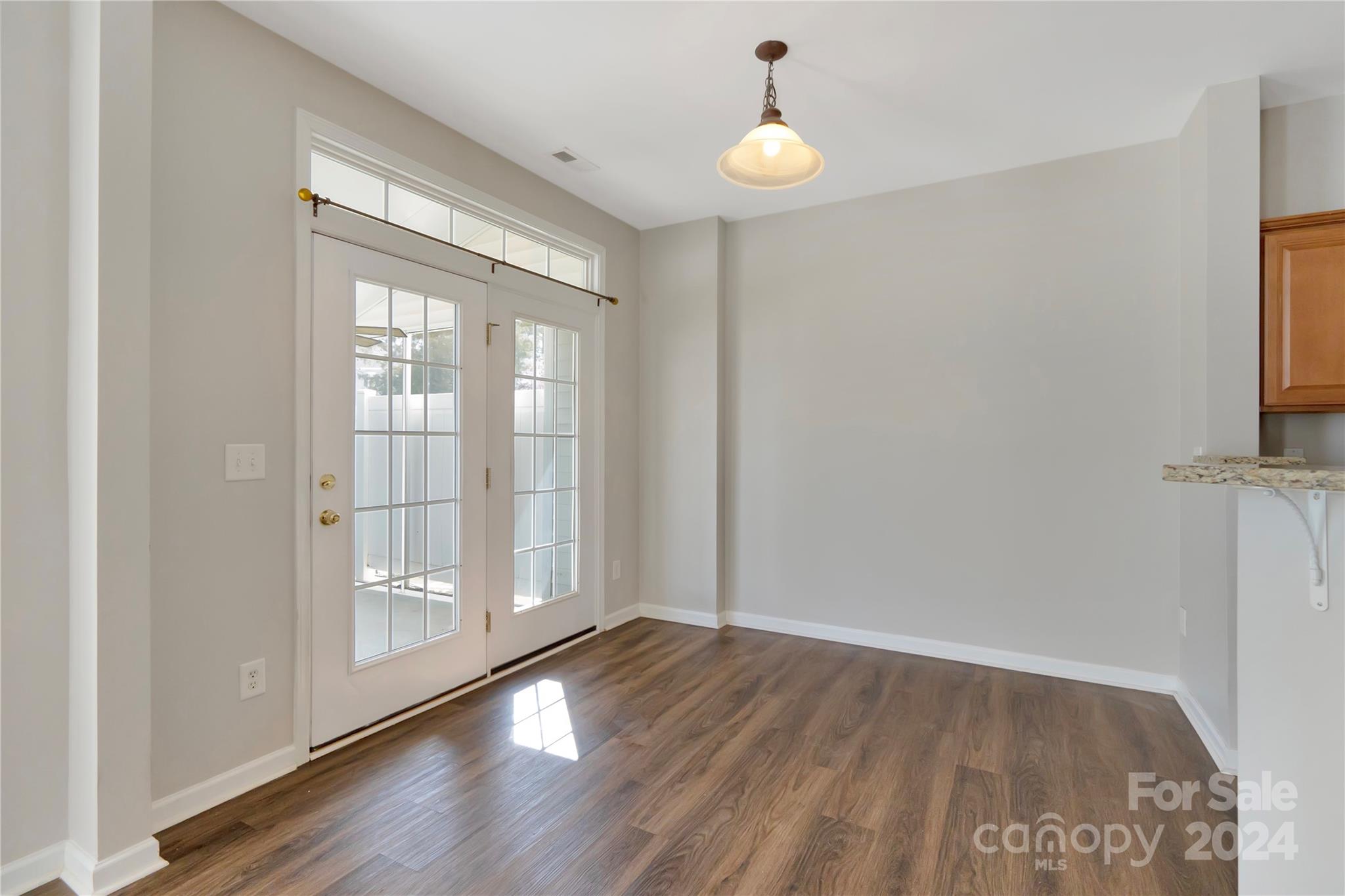 175 Snead Road Fort Mill, SC 29715 - Photo 11 of 26 an empty room with wooden floor and windows