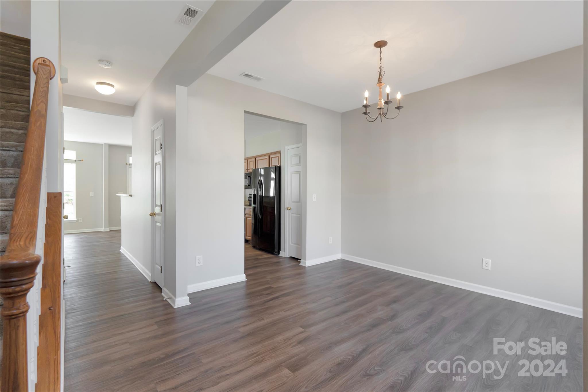 175 Snead Road Fort Mill, SC 29715 - Photo 2 of 26 a view of a hallway with wooden floor and a chandelier