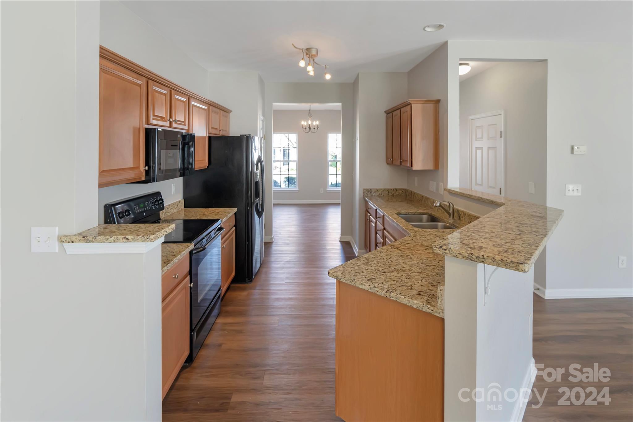 175 Snead Road Fort Mill, SC 29715 - Photo 7 of 26 a kitchen with stainless steel appliances granite countertop a refrigerator a stove and a wooden floors