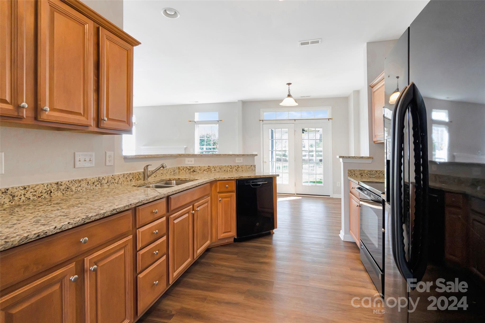 175 Snead Road Fort Mill, SC 29715 - Photo 10 of 26 a large kitchen with granite countertop a large counter top space a sink stainless steel appliances and cabinets