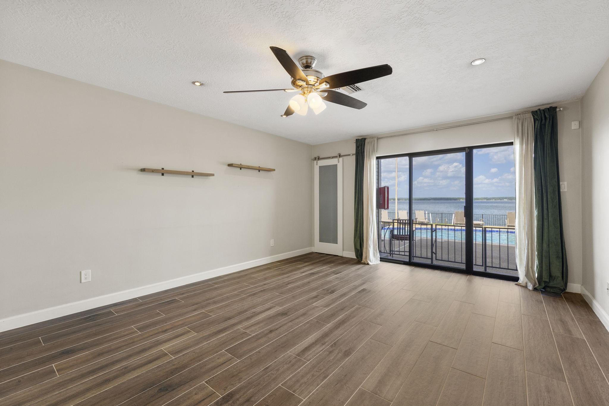 801 River Road, Unit 105C Montgomery, TX 77356 - Photo 14 of 30 The living room opens seamlessly to a private patio through sliding glass doors, extending your living space outdoors.