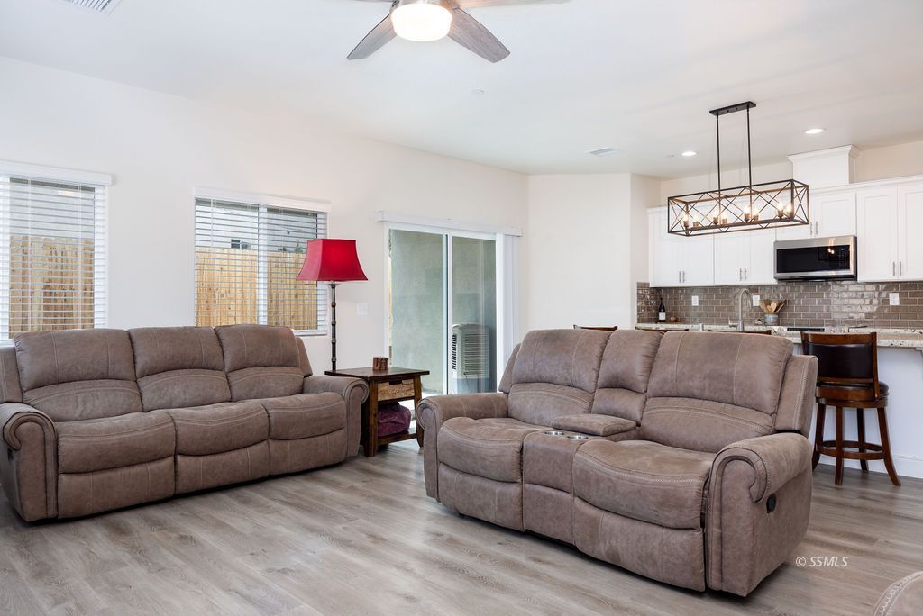1014 Ocean Avenue Ridgecrest, CA 93555 - Photo 12 of 37 a living room with furniture kitchen view and a chandelier