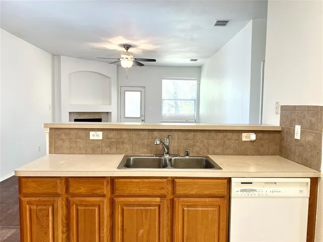 a view of a kitchen with a sink and dishwasher