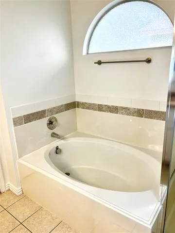 a bathroom with a tub and a shower