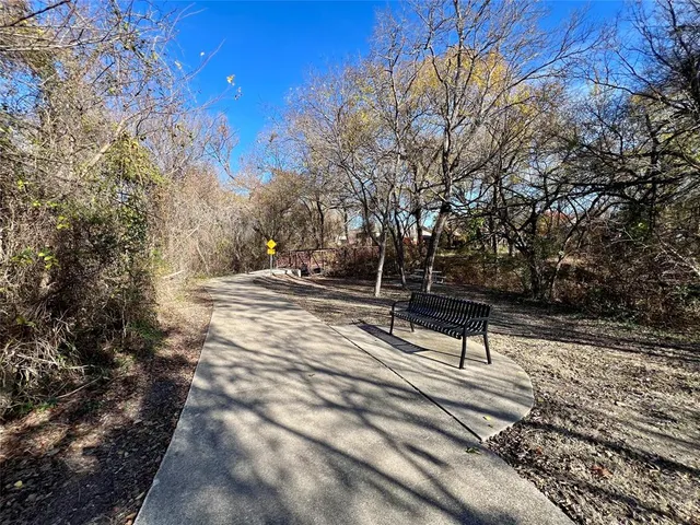 a view of house with backyard and trees