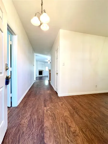 a view of a big room with wooden floor and cabinet