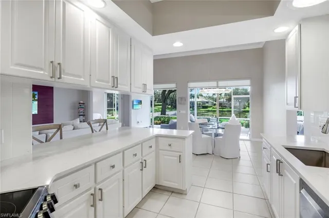 a kitchen with a white cabinets and window