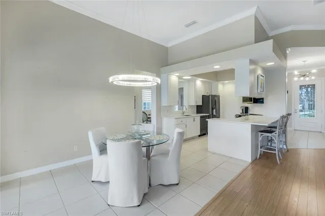a living room with furniture and a dining table with kitchen view