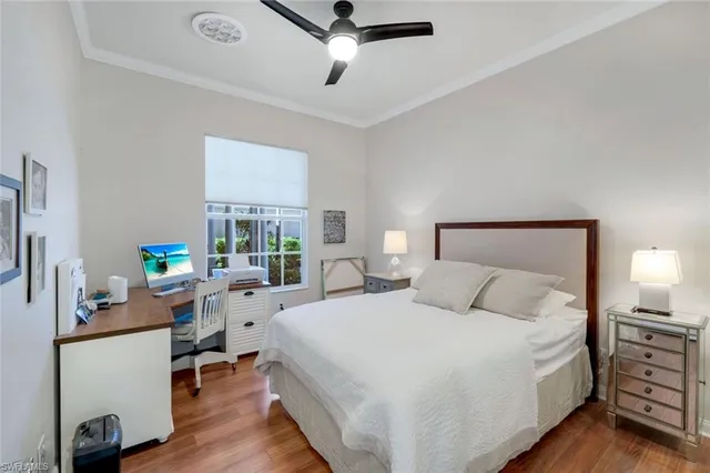 a bedroom with a bed and a desk