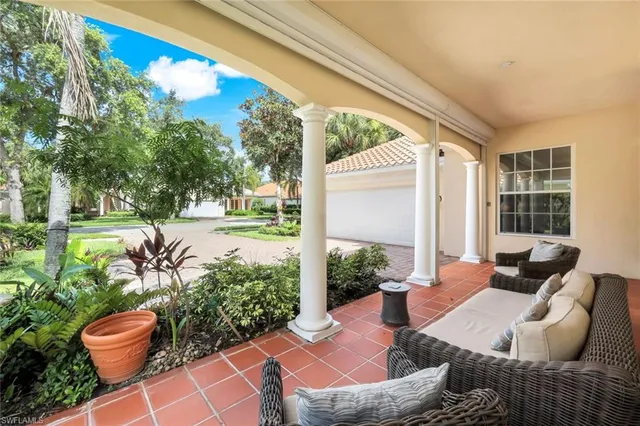 a view of a porch with furniture and floor to ceiling window
