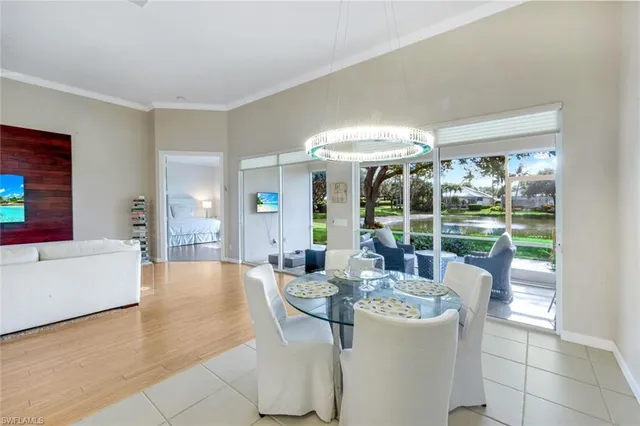 a dining room with furniture and large windows