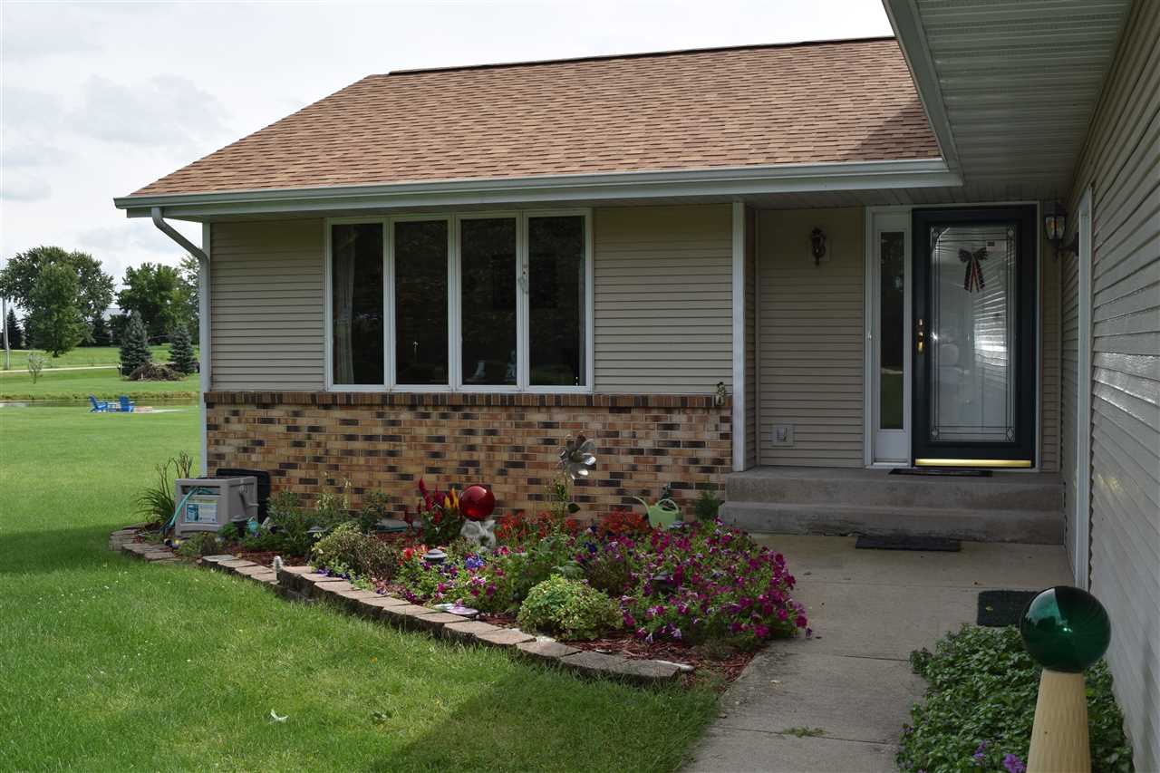 10937 Barron Road Chana, IL 61015 - Photo 3 of 23 a front view of a house with a garden
