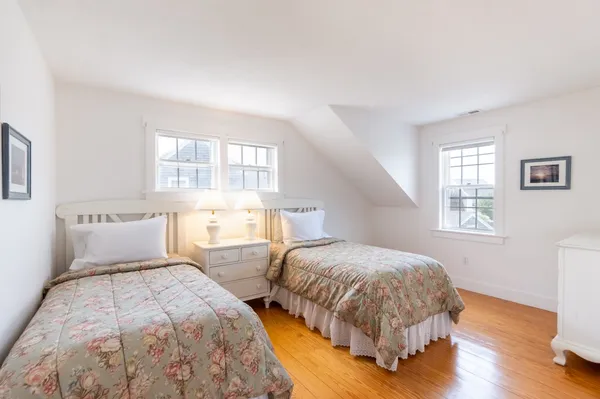 a bedroom with two beds and a window
