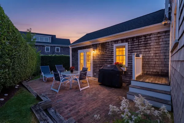a view of a backyard with sitting area