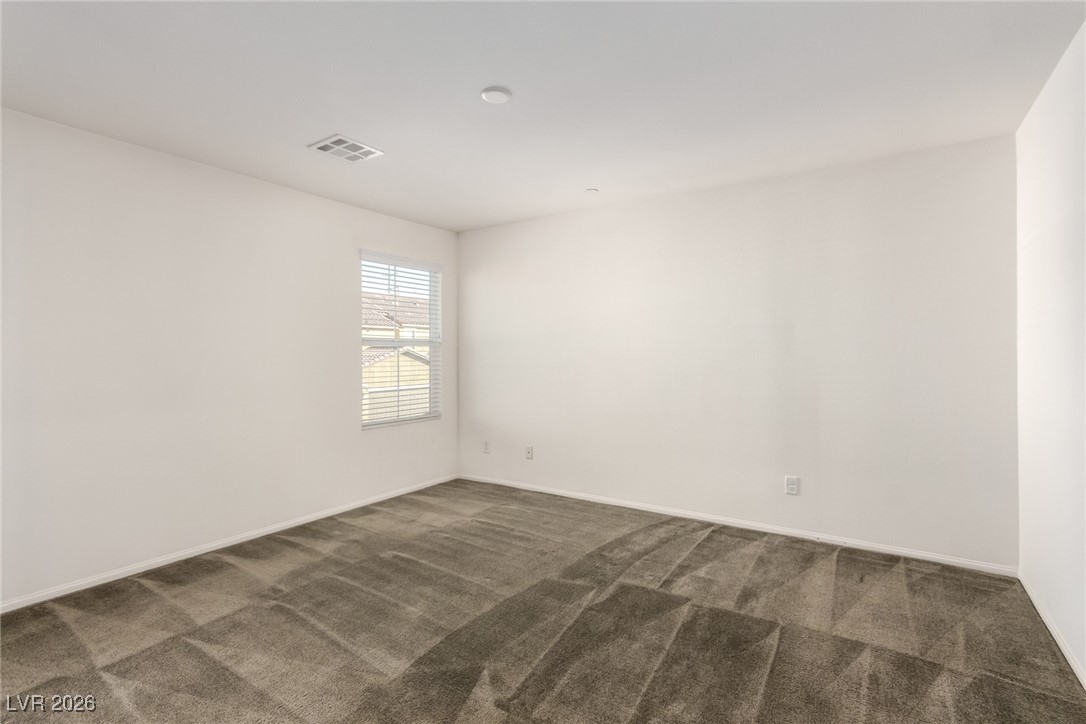 2862 Turnstone Ridge Street Henderson, NV 89044 - Photo 15 of 30 Unfurnished room with dark colored carpet and baseboards