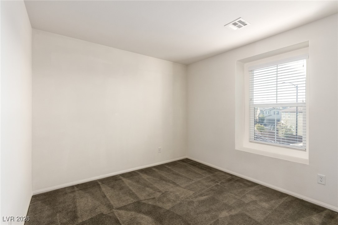 2862 Turnstone Ridge Street Henderson, NV 89044 - Photo 18 of 30 Spare room with dark colored carpet and baseboards