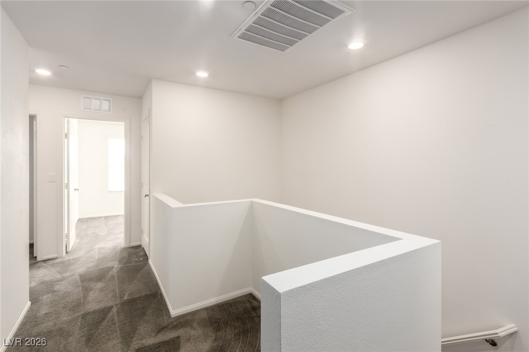2862 Turnstone Ridge Street Henderson, NV 89044 - Photo 23 of 30 Hallway featuring an upstairs landing, dark colored carpet, and recessed lighting