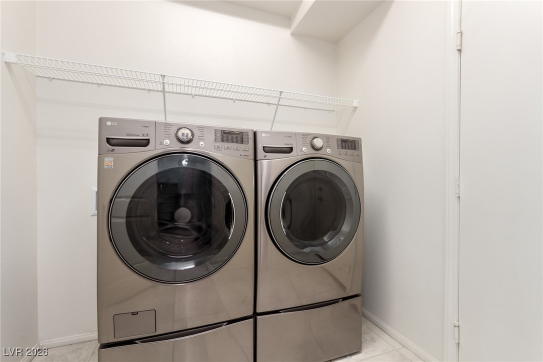 2862 Turnstone Ridge Street Henderson, NV 89044 - Photo 24 of 30 Laundry area with washer and dryer and baseboards