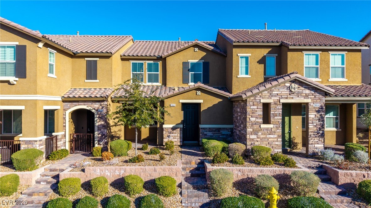 2862 Turnstone Ridge Street Henderson, NV 89044 - Photo 25 of 30 Mediterranean / spanish-style house with stone siding, stucco siding, and a tile roof