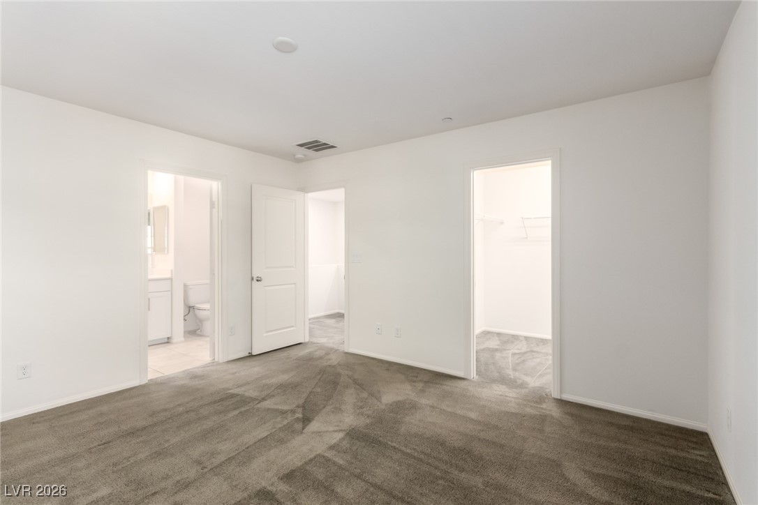 2862 Turnstone Ridge Street Henderson, NV 89044 - Photo 5 of 30 Unfurnished bedroom with a spacious closet, carpet, and ensuite bathroom