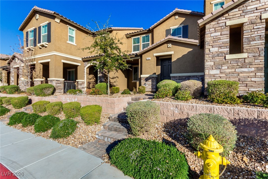 2862 Turnstone Ridge Street Henderson, NV 89044 - Photo 9 of 30 Mediterranean / spanish home with stone siding, stucco siding, and a tile roof