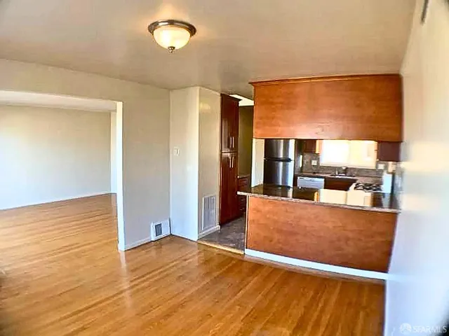 a living room with hardwood floor to ceiling window and wooden floor